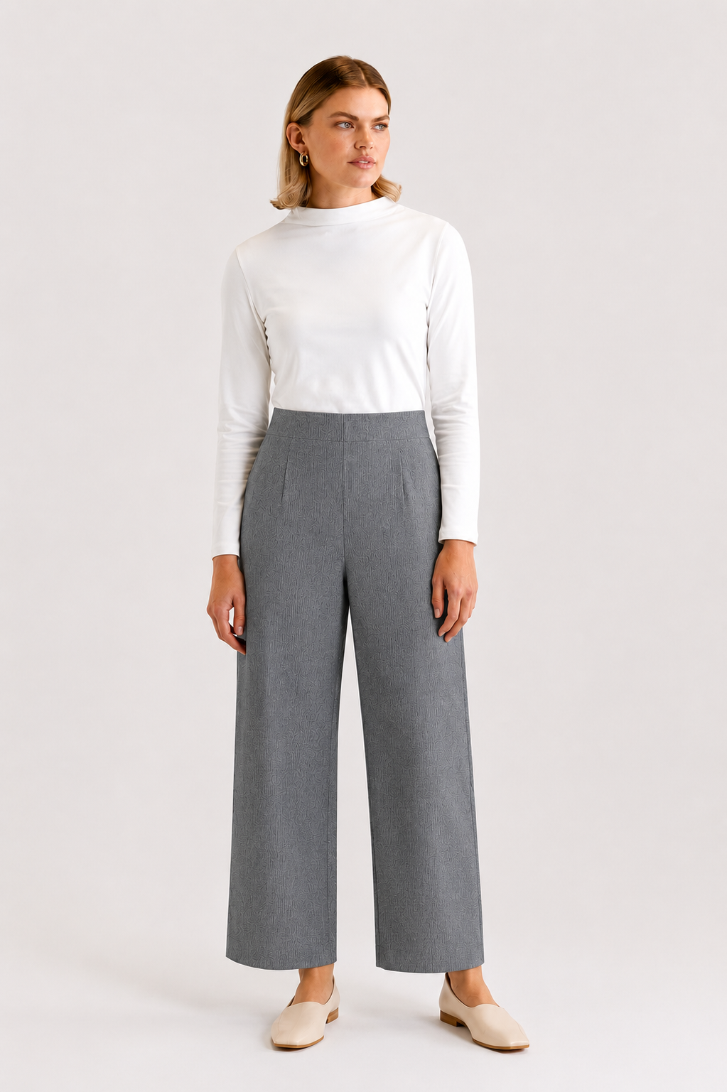 Model wearing the Monica Wool Trouser is grey with the Peta Funnel neck Top