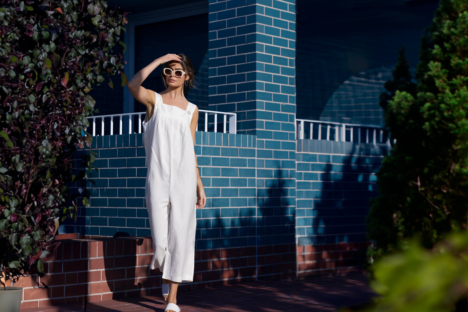 Australian-made minimalist clothing displayed in a natural setting, showcasing a capsule wardrobe outfit with timeless style for workwear or summer.