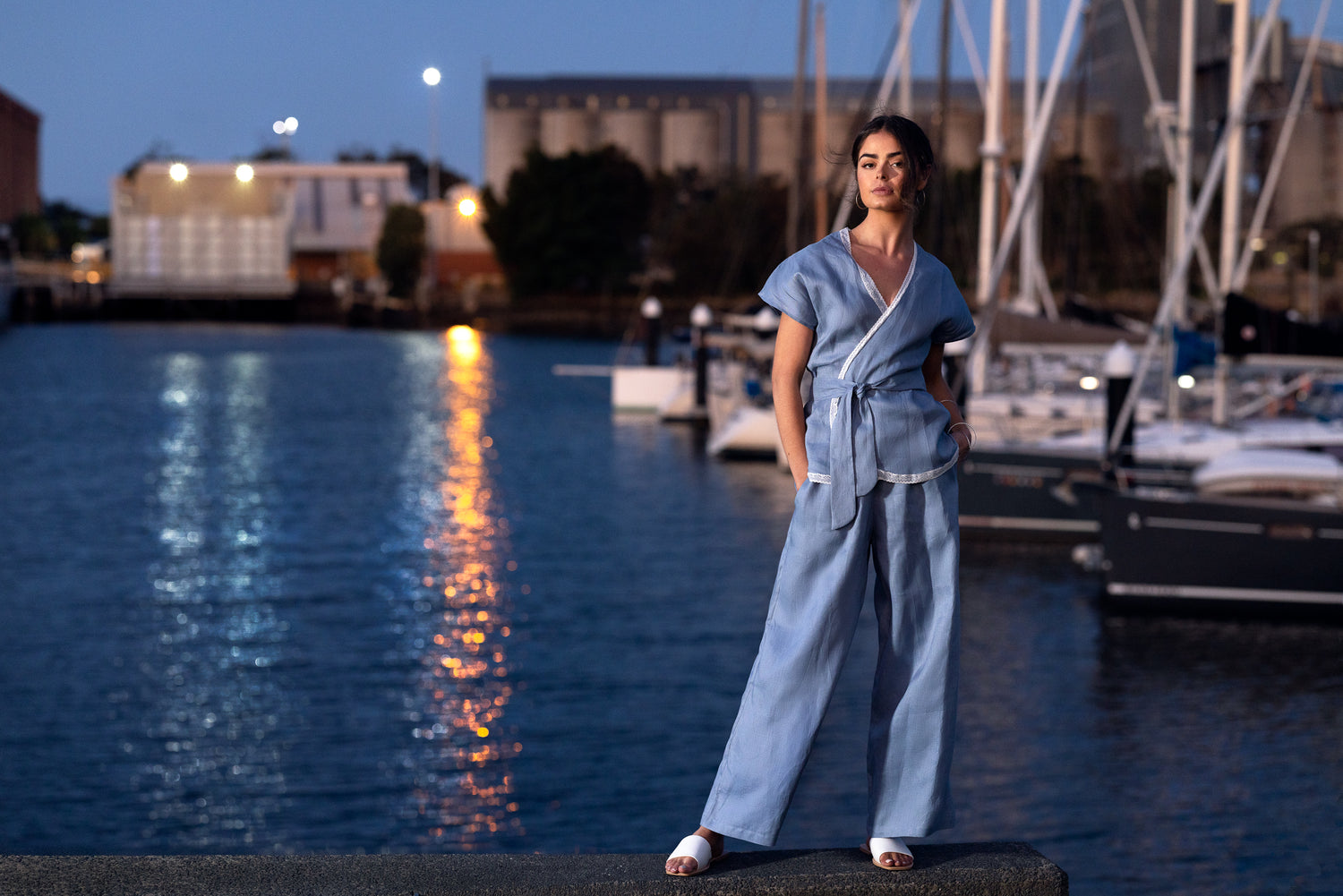 Australian-made minimalist clothing displayed in a natural setting, showcasing a capsule wardrobe outfit with timeless style for workwear or summer.