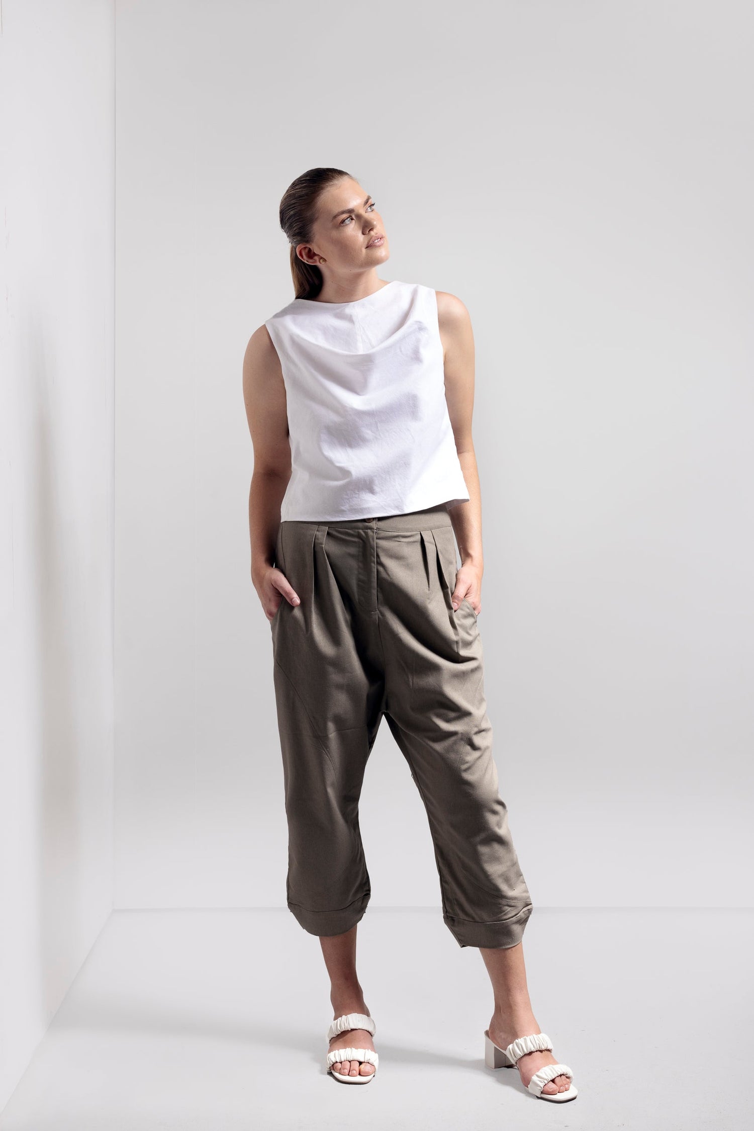 Model wearing the white Waves Top and Olive Peta Cocoon Pant from VOUS- an Australian made minimalist clothing brand.